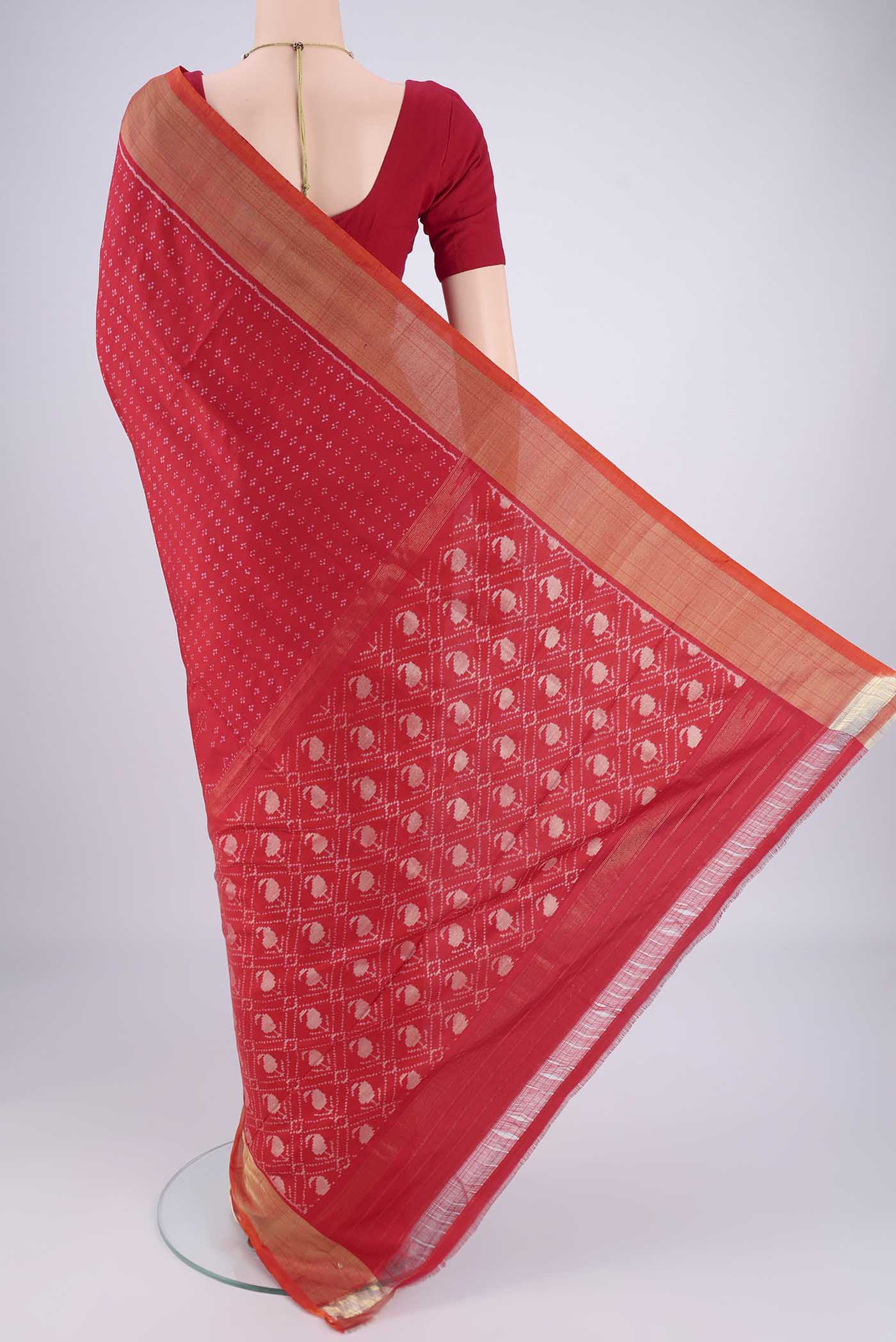 Flat view of Red Pochampally Silk Saree with Ikat design on the body and Zari Border. 