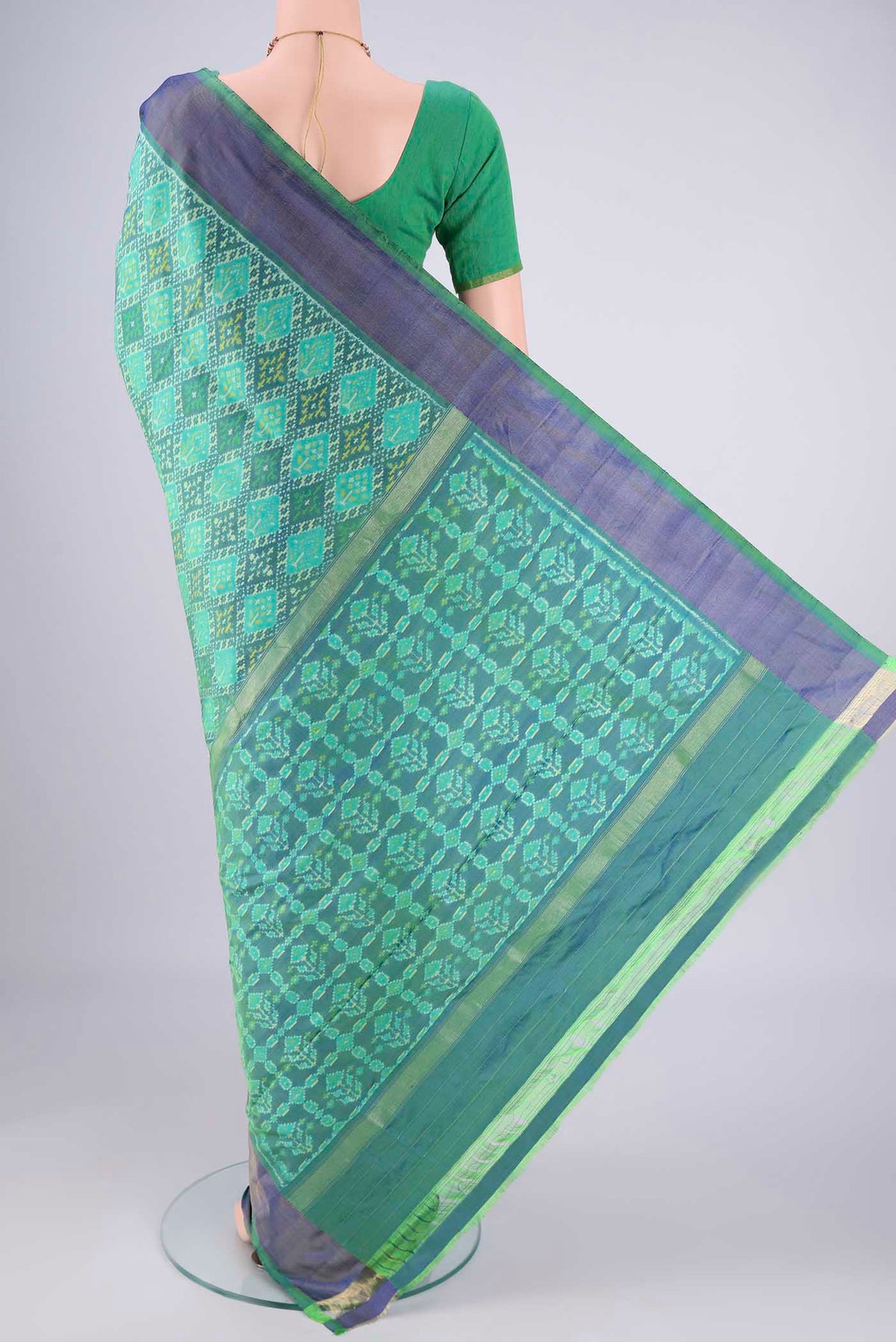 Flat view of Sea Green Pochampally Silk Saree with Ikat design on the body and Zari Border. 