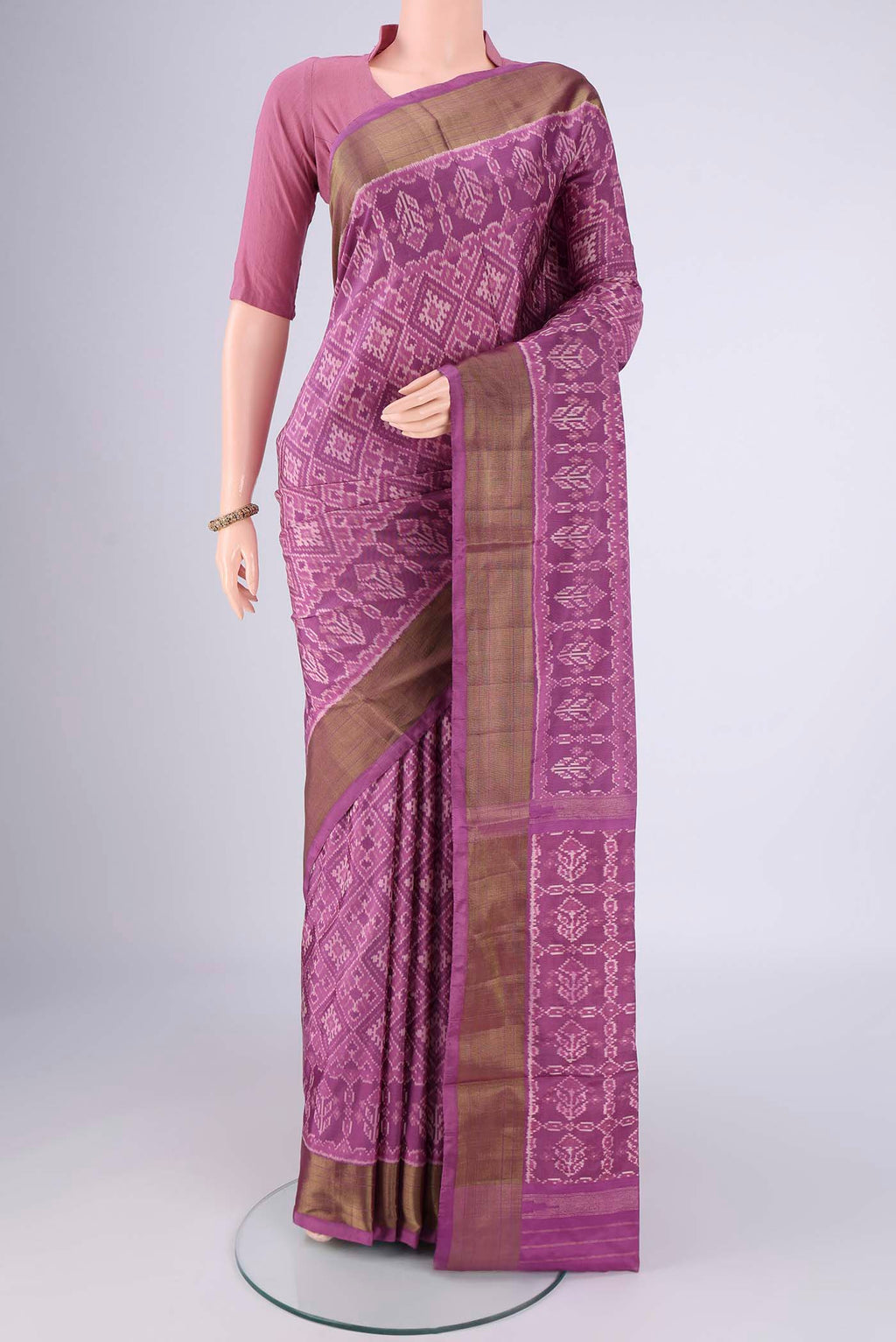 Purple Pochampally Silk Saree with Ikat design on the body and Zari Border.  displayed on a mannequin