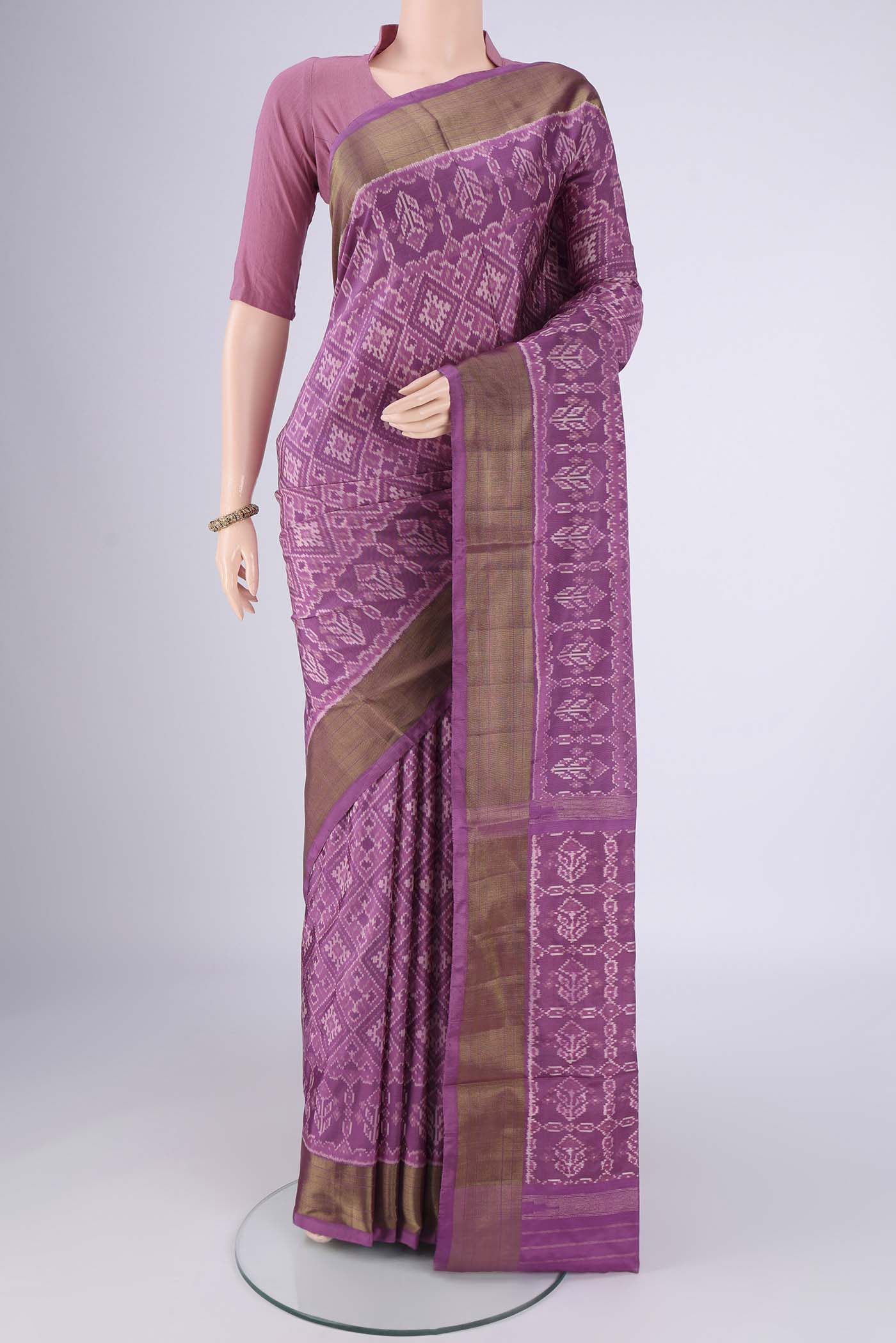 Purple Pochampally Silk Saree with Ikat design on the body and Zari Border.  displayed on a mannequin