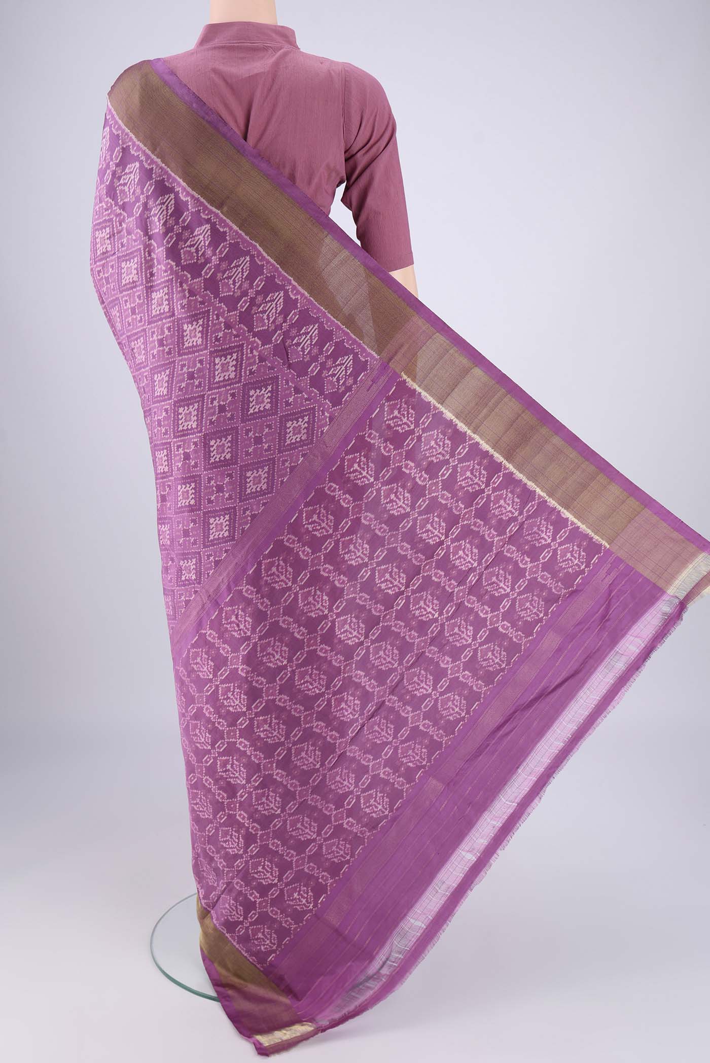 Flat view of Purple Pochampally Silk Saree with Ikat design on the body and Zari Border. 