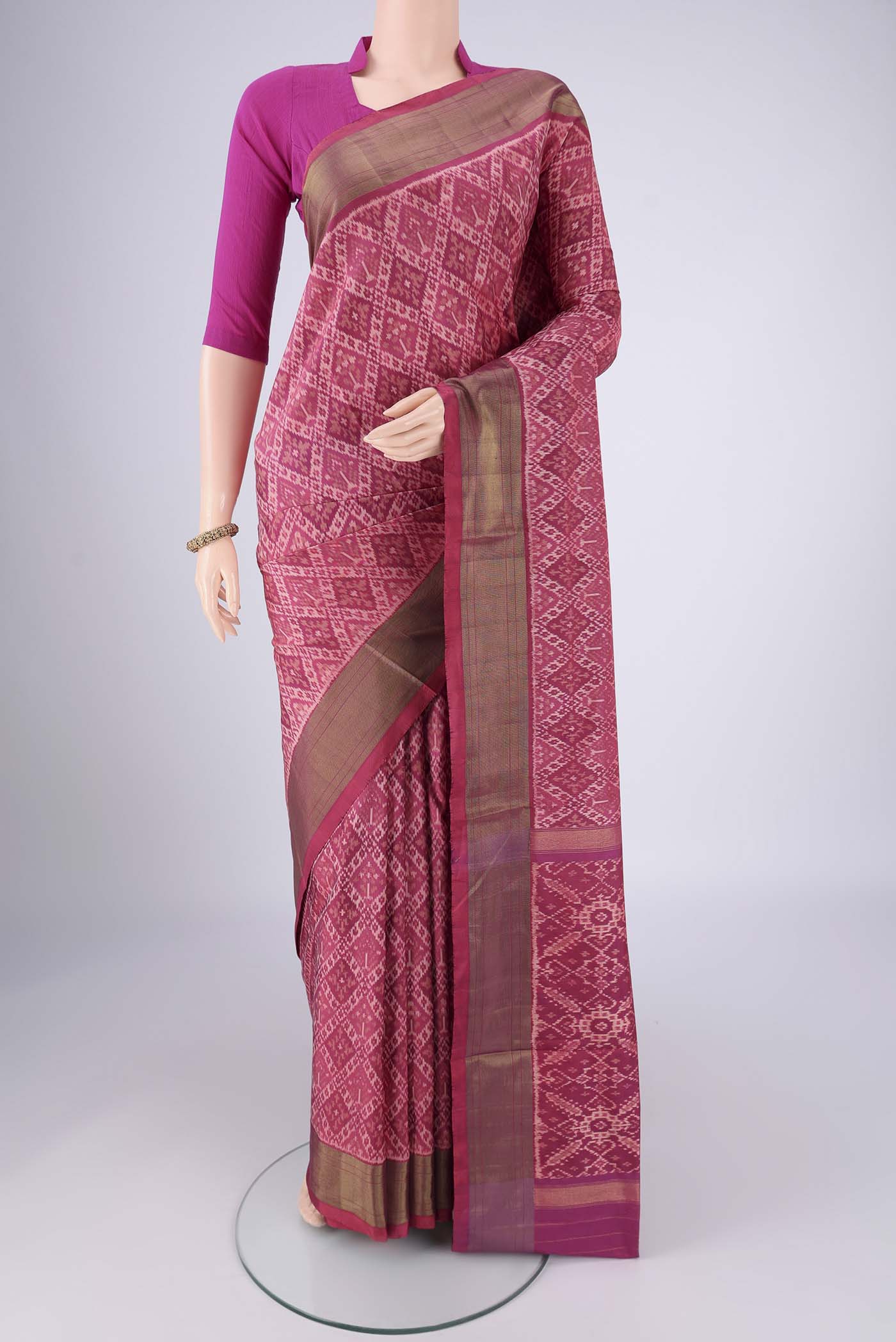 Rose Gold Pochampally Silk Saree with Ikat design on the body and Zari Border.  displayed on a mannequin