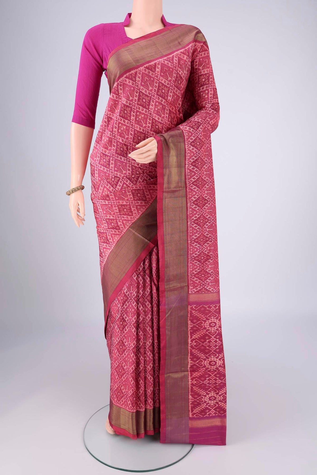 Rose Gold Pochampally Silk Saree with Ikat design on the body and Zari Border.  displayed on a mannequin