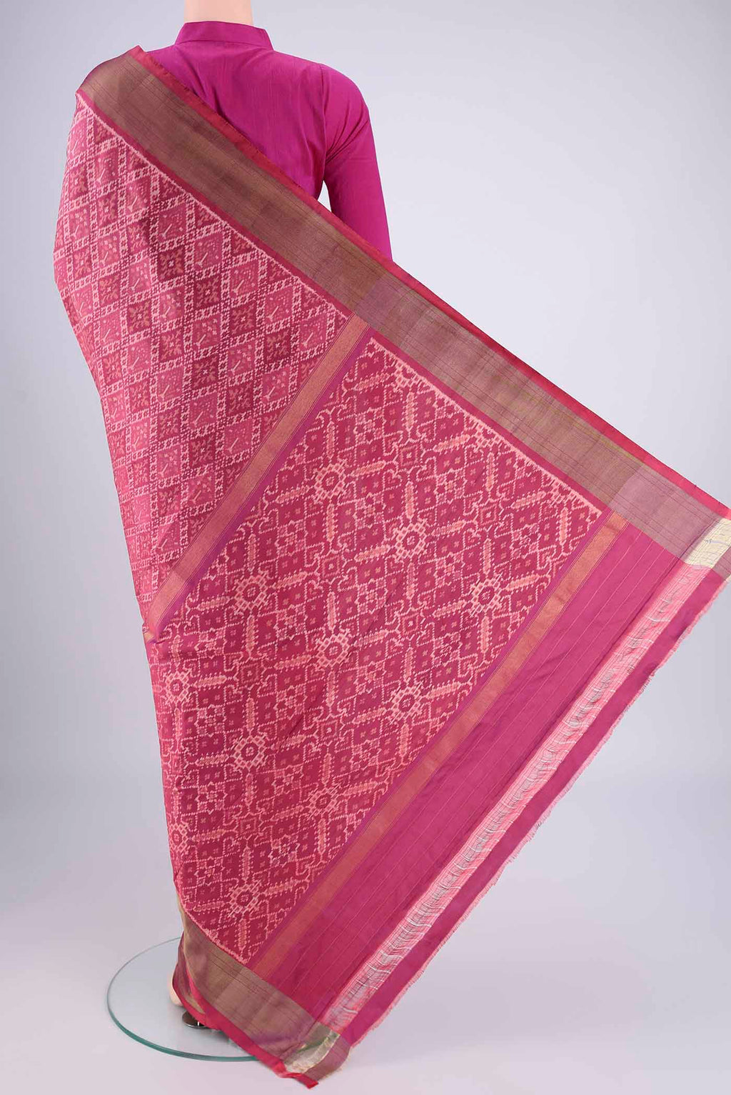 Flat view of Rose Gold Pochampally Silk Saree with Ikat design on the body and Zari Border. 