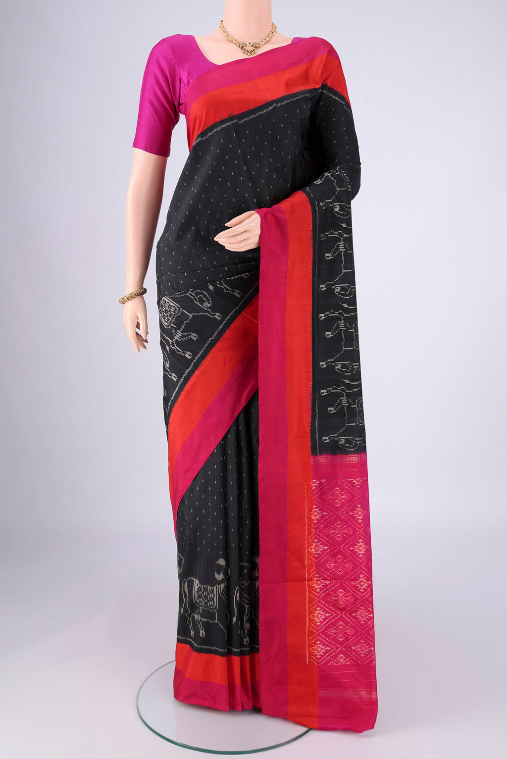 Black Pochampally Silk Saree with Ikat design on the body and Plain Border.  displayed on a mannequin