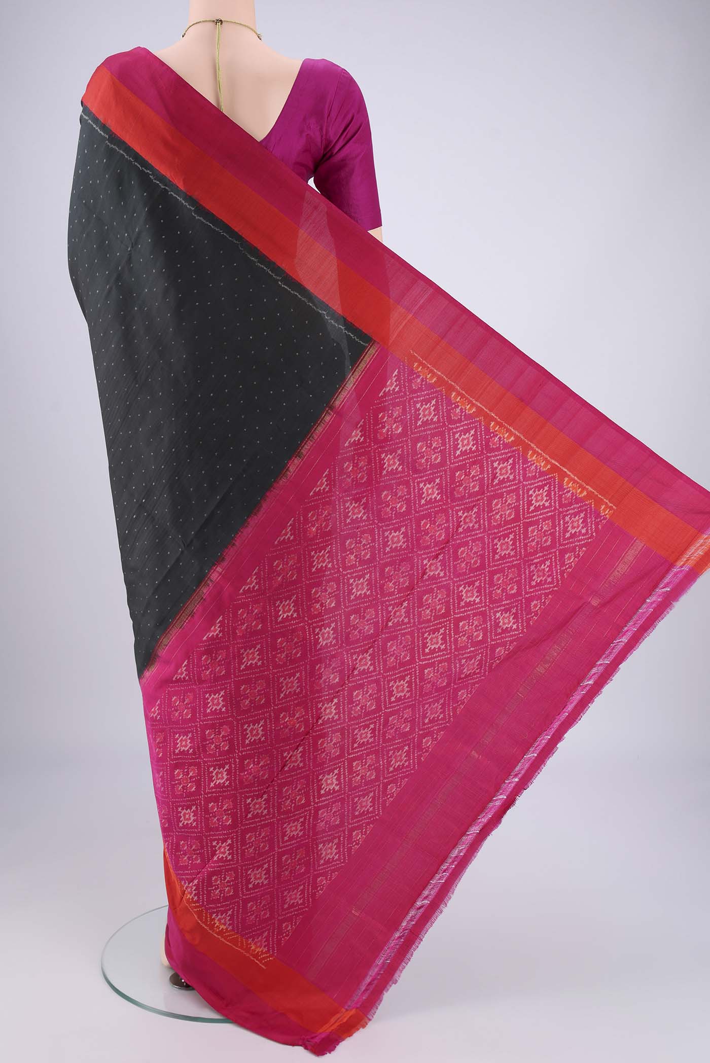 Flat view of Black Pochampally Silk Saree with Ikat design on the body and Plain Border. 