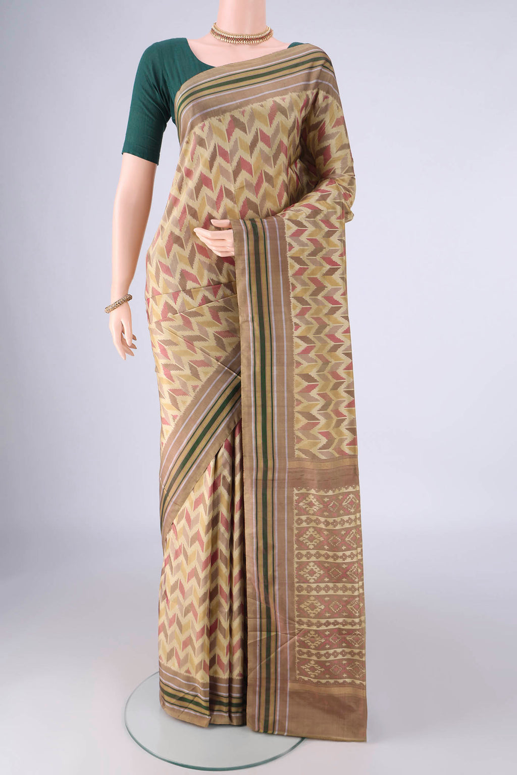 Beige Pochampally Silk Saree with Pure Ikat on the body and Plain Border.  displayed on a mannequin