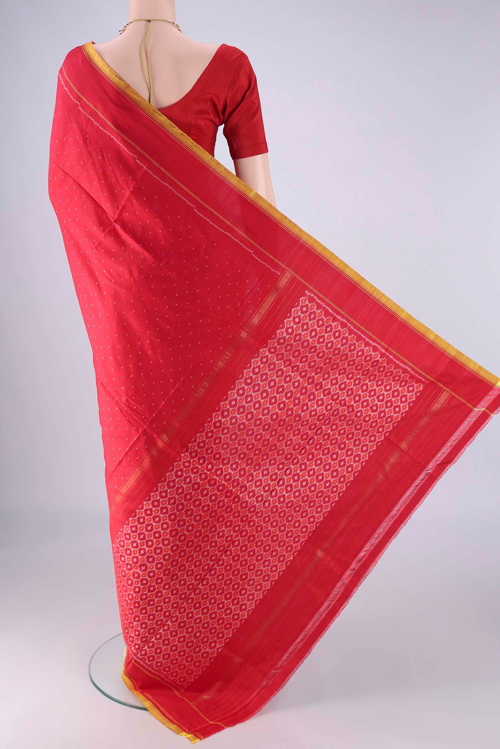 Flat view of Red Kanjivaram Silk Saree with Pure Ikat on the body and Plain Border. 