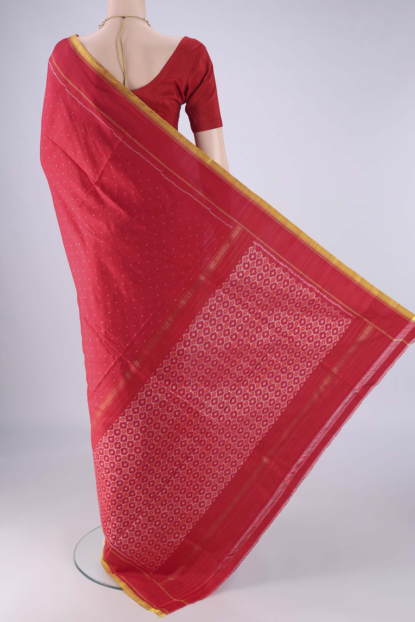 Flat view of Red Kanjivaram Silk Saree with Pure Ikat on the body and Plain Border. 