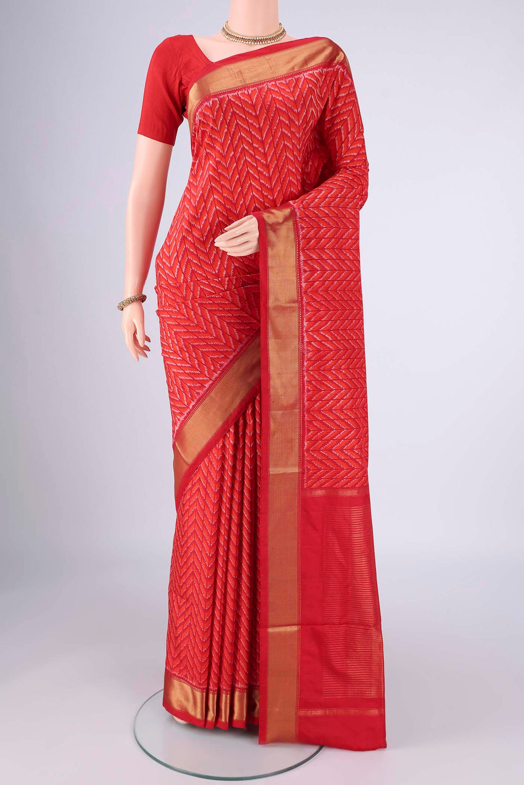 Red Pochampally Silk Saree with Pure Ikat on the body and Zari Border.  displayed on a mannequin