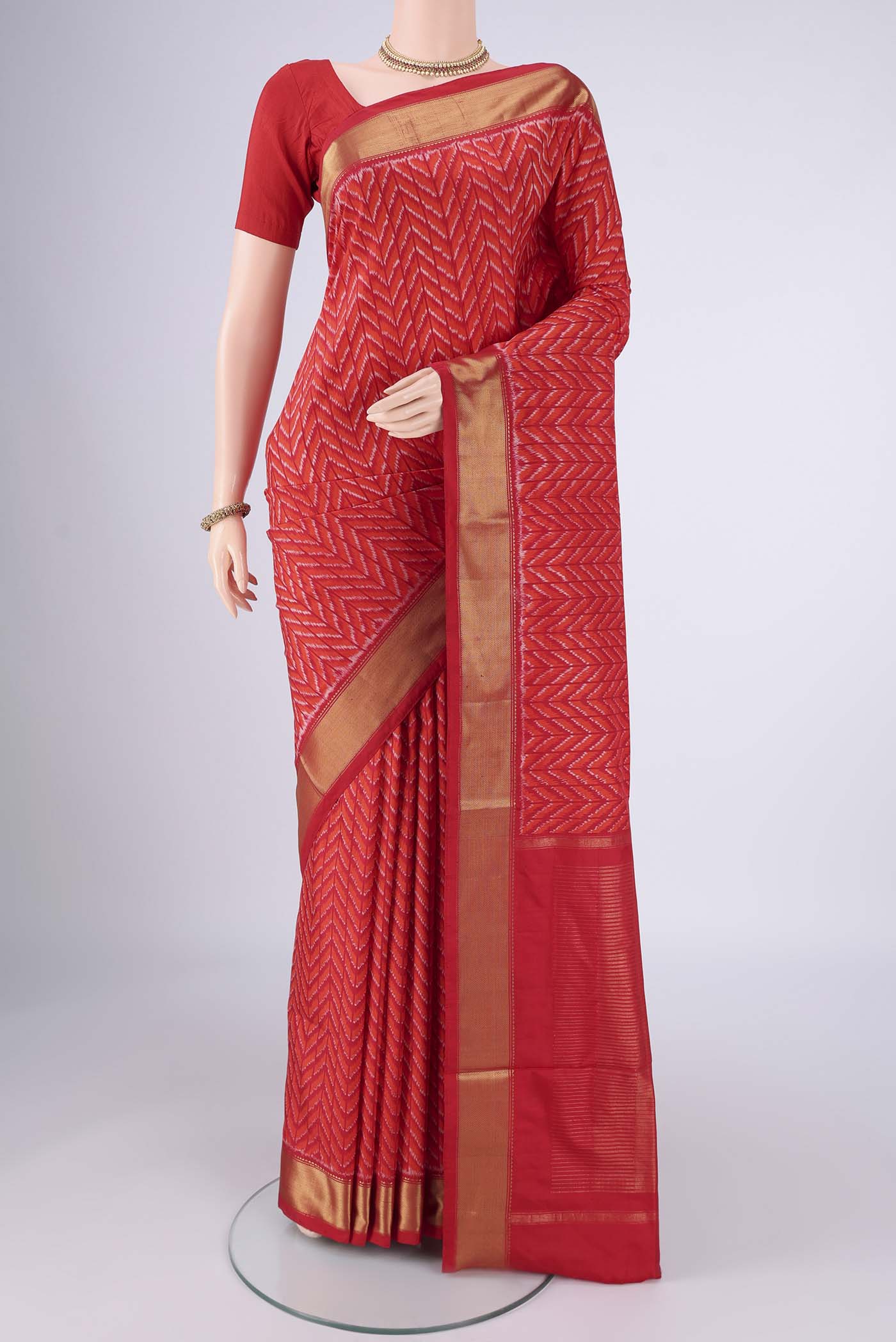 Red Pochampally Silk Saree with Pure Ikat on the body and Zari Border.  displayed on a mannequin