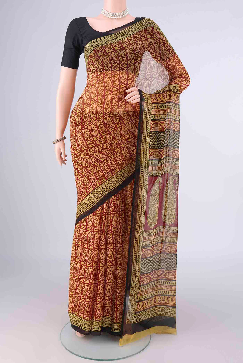 Maroon Mysore Chiffon Saree with Paisley on the body and Printed Border.  displayed on a mannequin