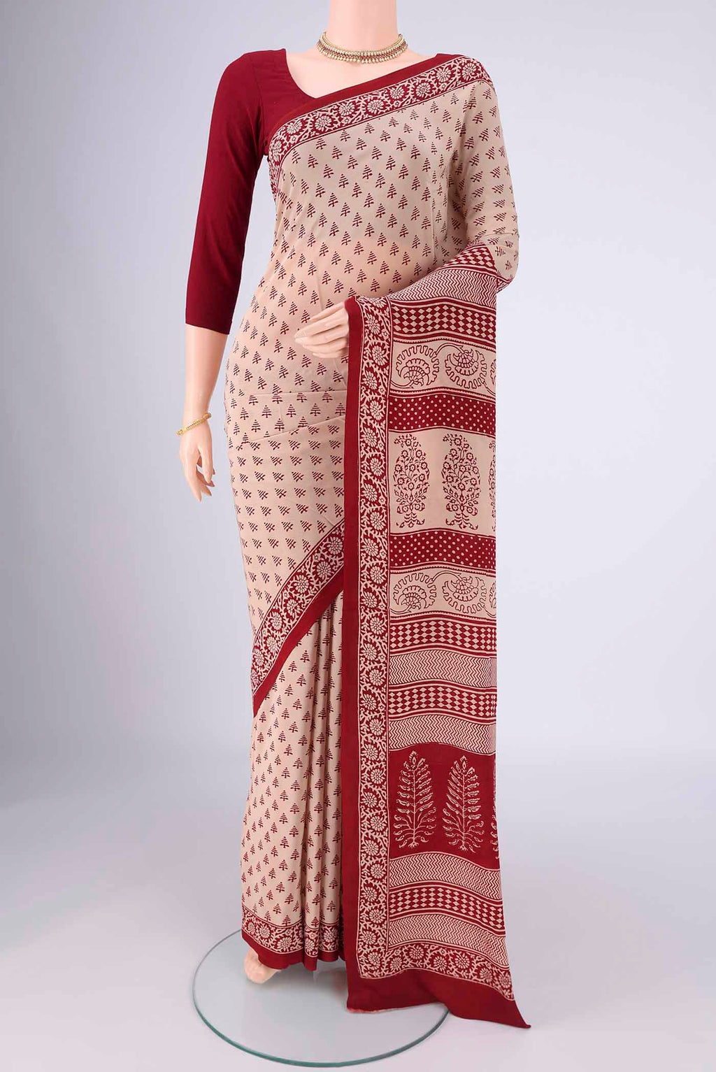 Beige Mysore Crepe Saree with Printed design on the body and Printed Border.  displayed on a mannequin
