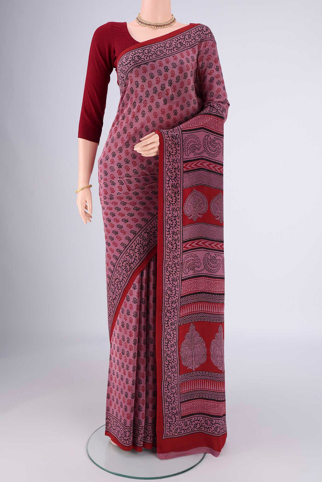 Dark Mauve Mysore Crepe Saree with Printed design on the body and Printed Border.  displayed on a mannequin