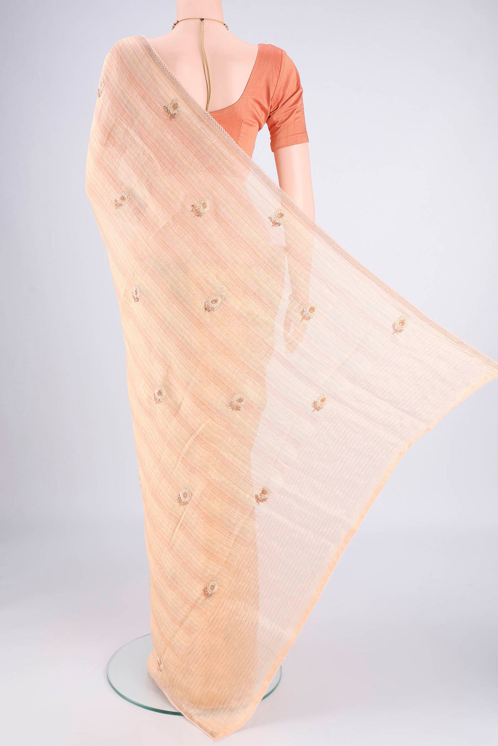 Flat view of Golden Peach Linen Saree with Embroidery on the body and Lace Border. 