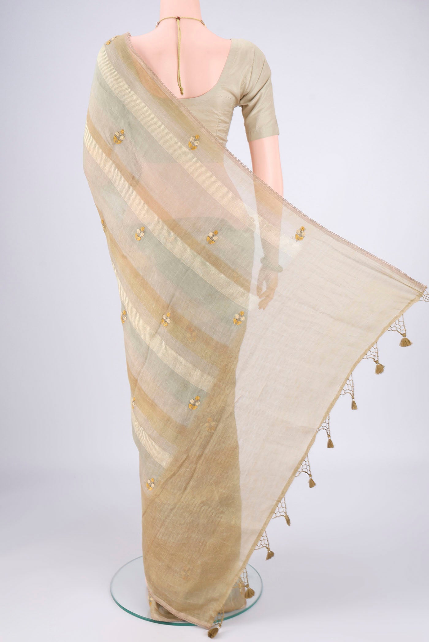 Flat view of Sage Green Linen Saree with Embroidery on the body and Lace Border. 