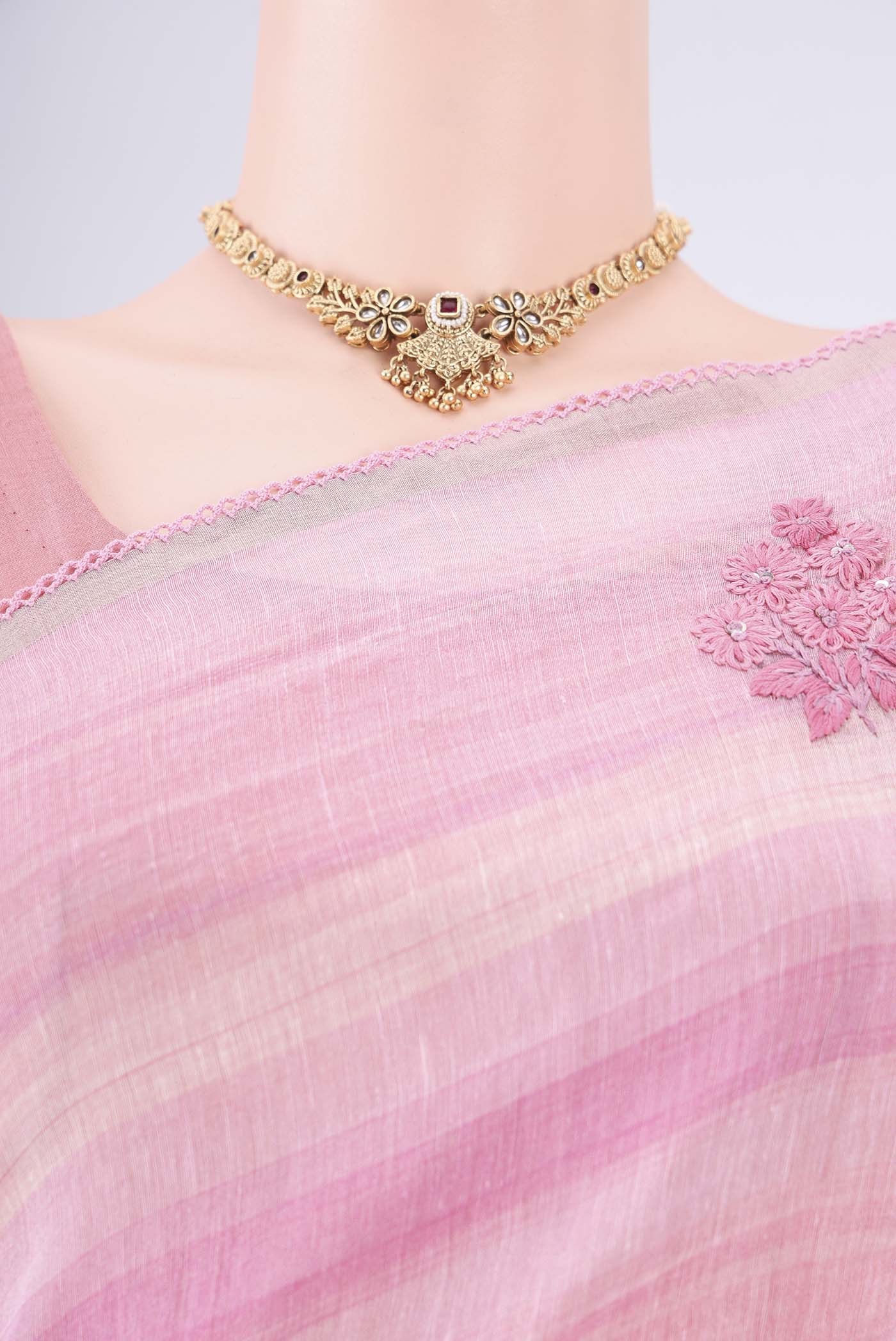Border image of Pink Linen Saree with Embroidery on the body and Lace Border. 