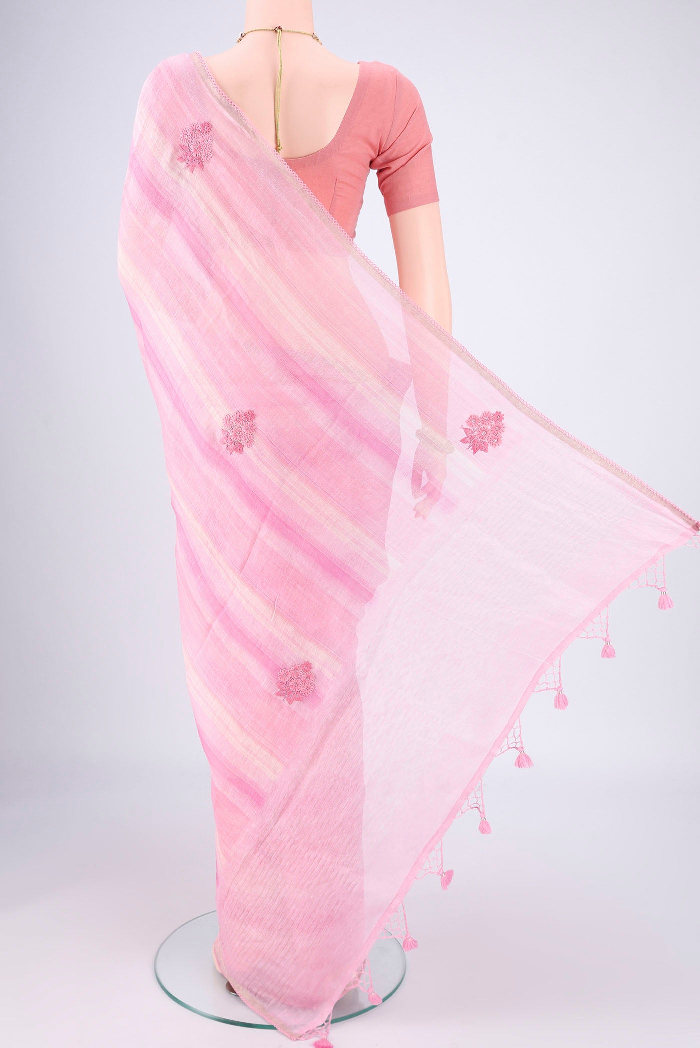 Flat view of Pink Linen Saree with Embroidery on the body and Lace Border. 