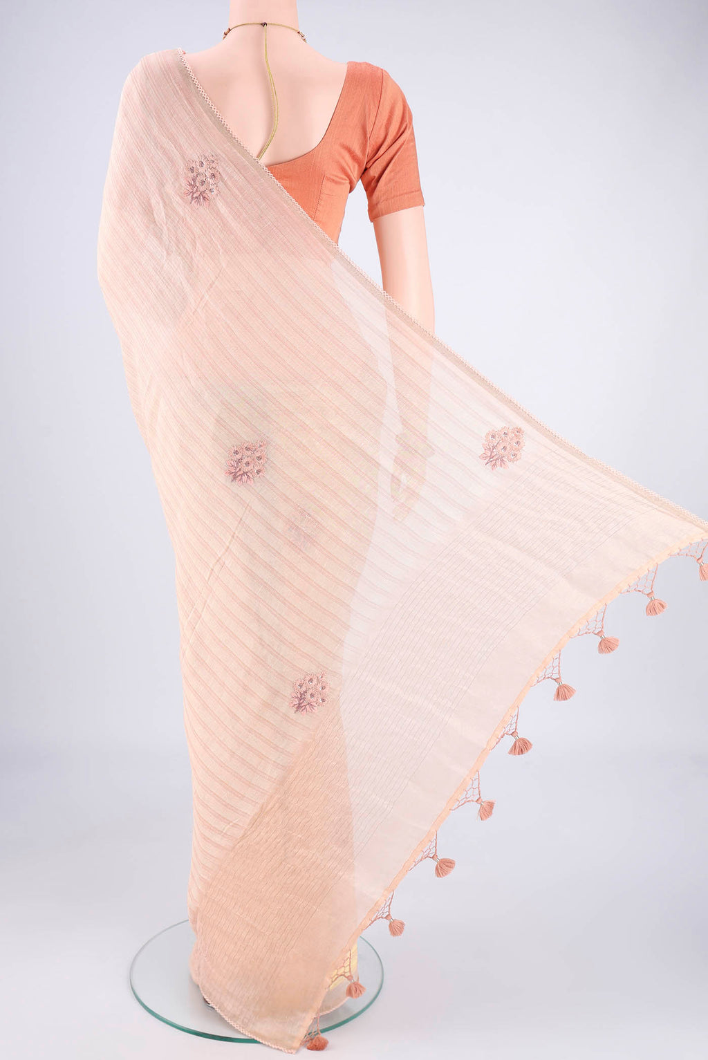 Flat view of Golden Peach Linen Saree with Embroidery on the body and Lace Border. 
