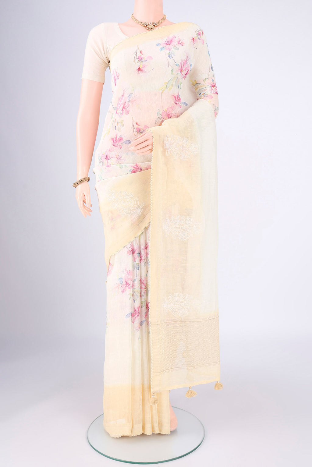 Lemon Yellow Linen Saree with Printed design on the body and Lace Border.  displayed on a mannequin
