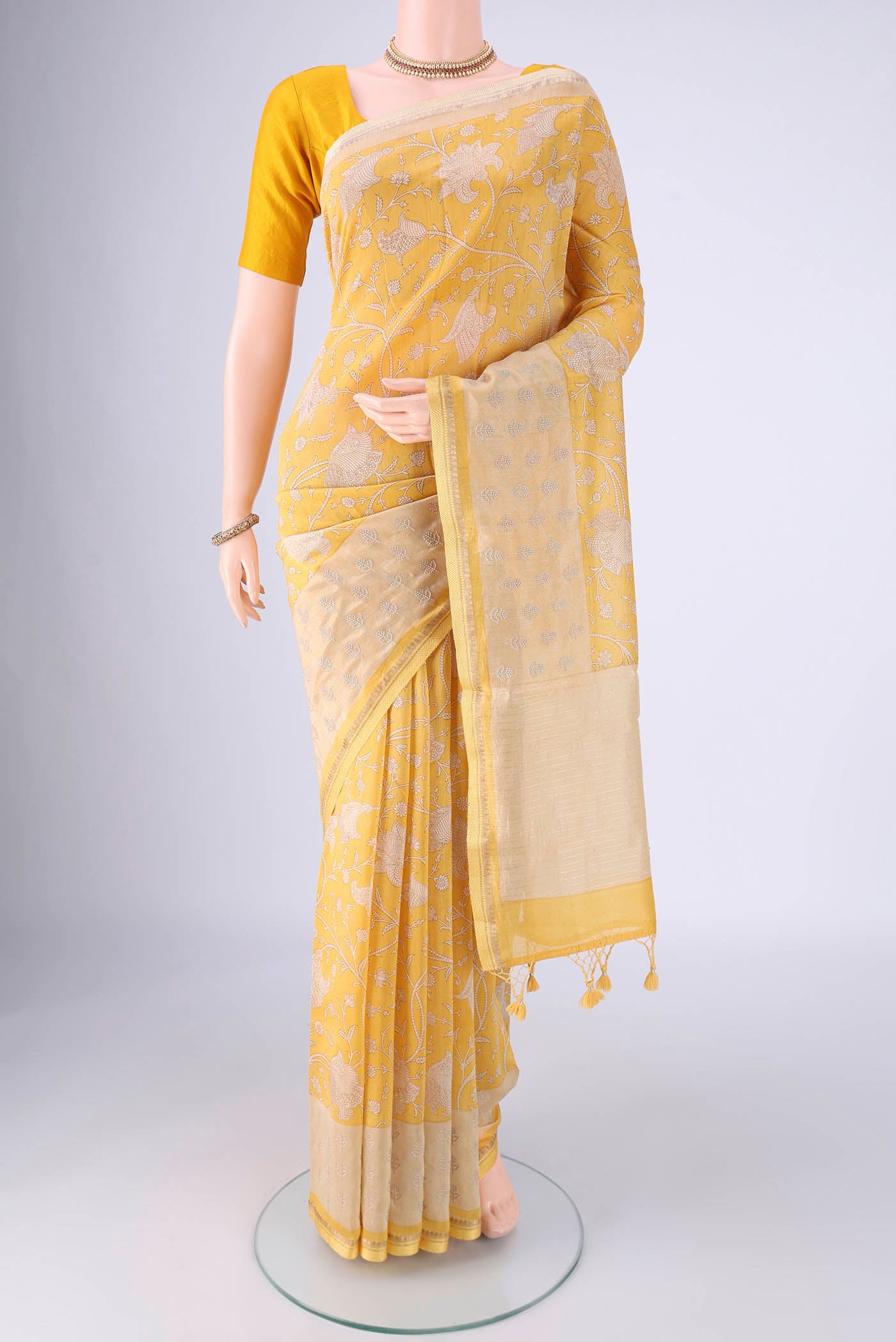 Lemon Yellow Chanderi Silk Cotton Saree with Printed design on the body and Zari And Thread Border.  displayed on a mannequin