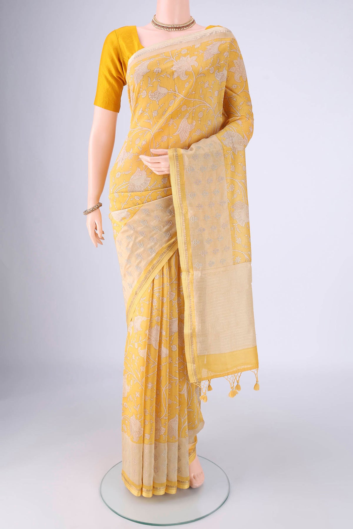 Lemon Yellow Chanderi Silk Cotton Saree with Printed design on the body and Zari And Thread Border.  displayed on a mannequin