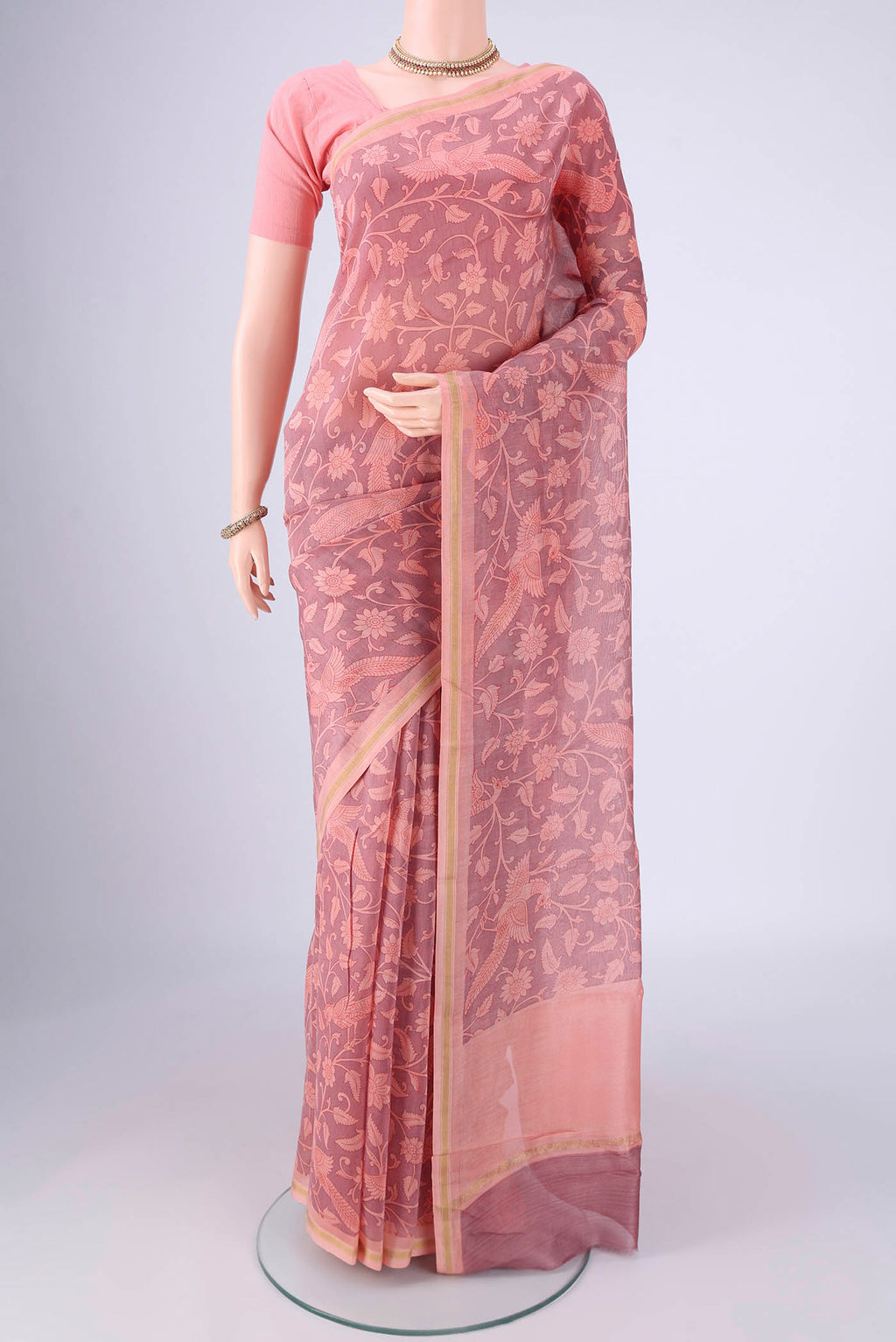 Rose pink Chanderi Silk Cotton Saree with Printed design on the body and Zari Border.  displayed on a mannequin