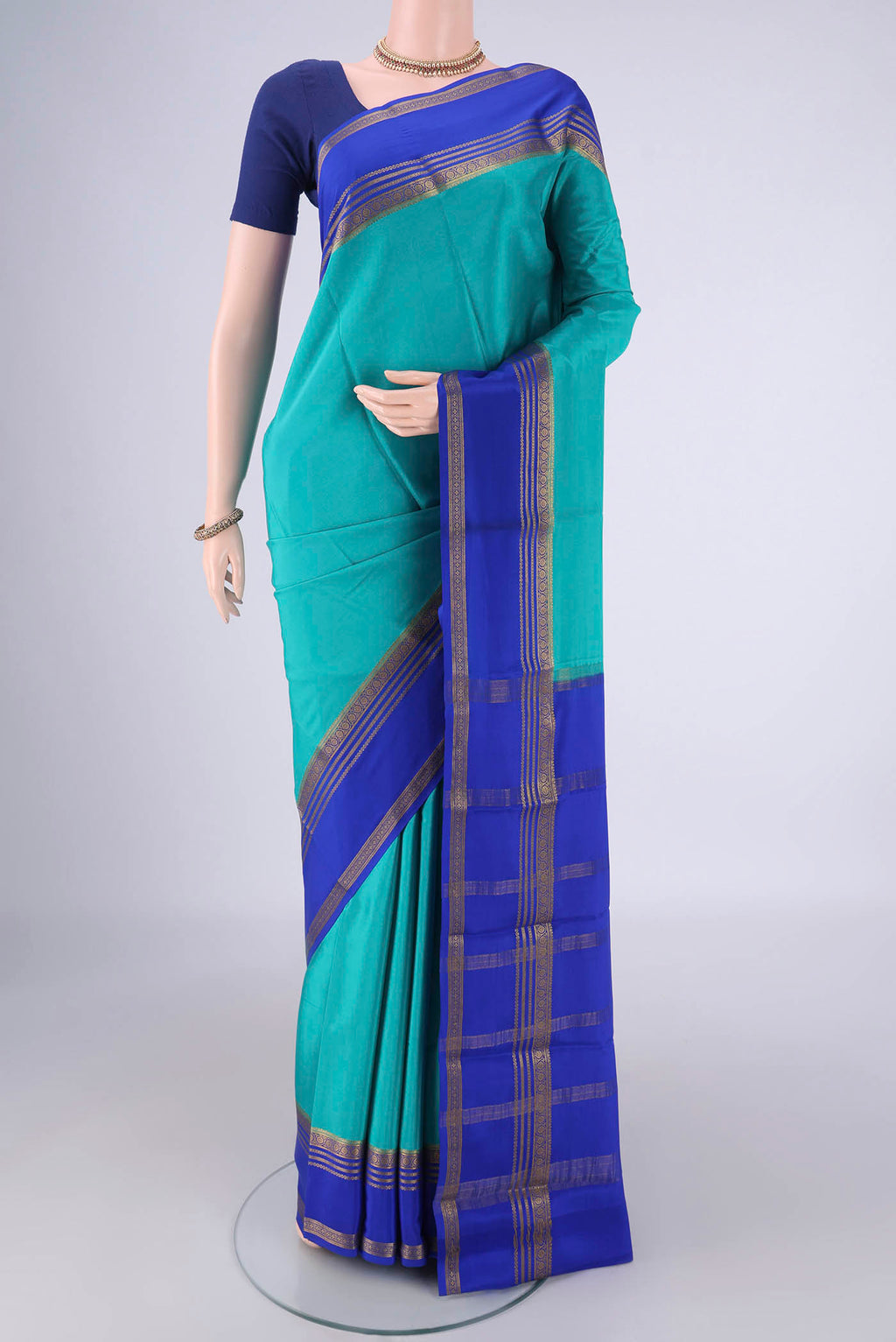 Turquoise Mysore Crepe Saree with Plain Body and Zari Border.  displayed on a mannequin