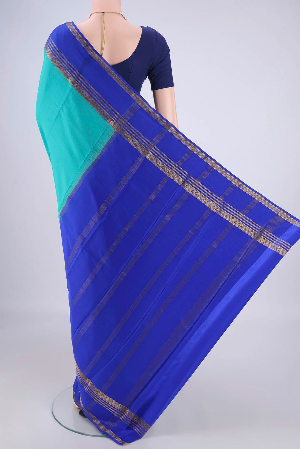 Flat view of Turquoise Mysore Crepe Saree with Plain Body and Zari Border. 