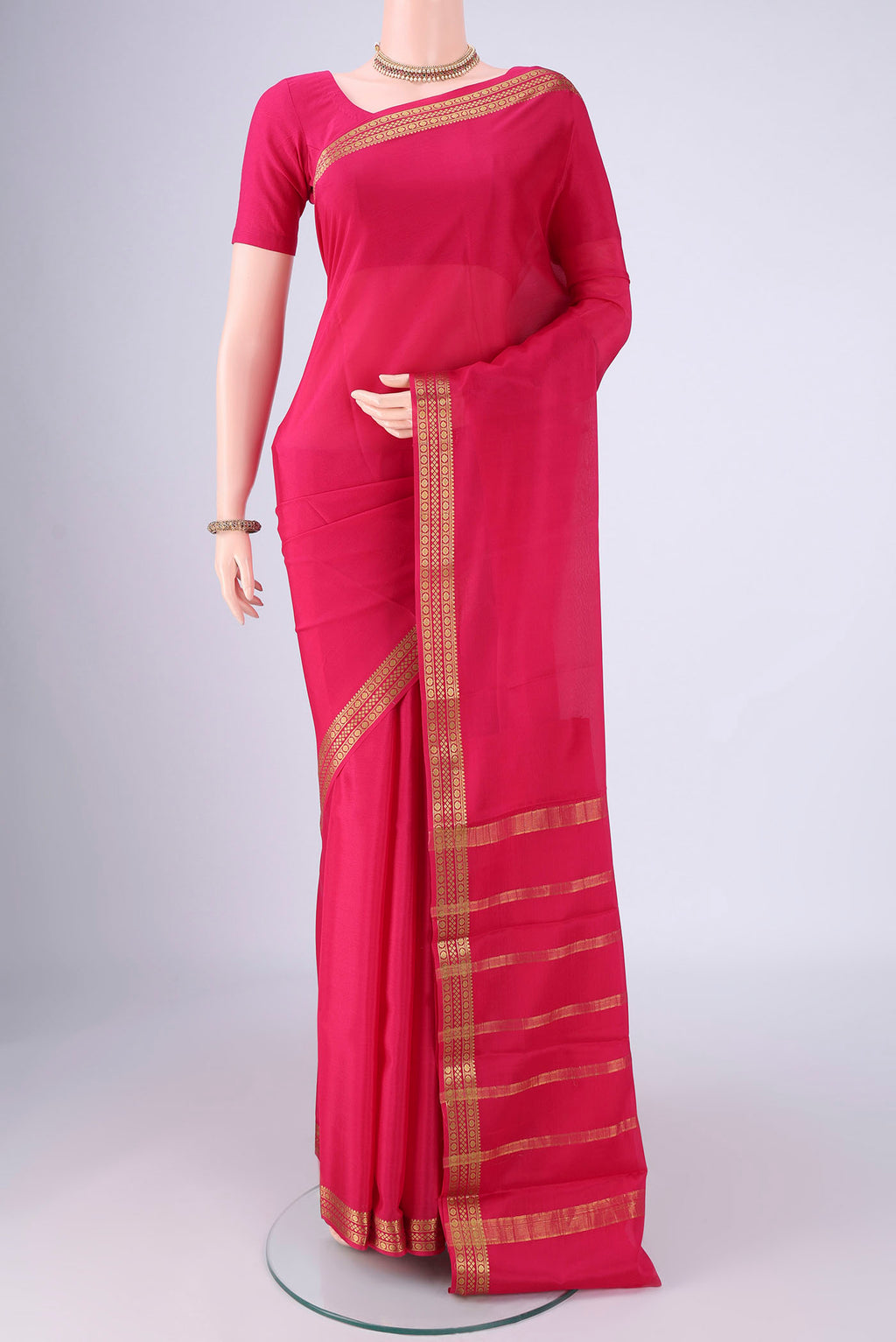 Rani Pink Mysore Crepe Saree with Plain Body and Zari Border.  displayed on a mannequin