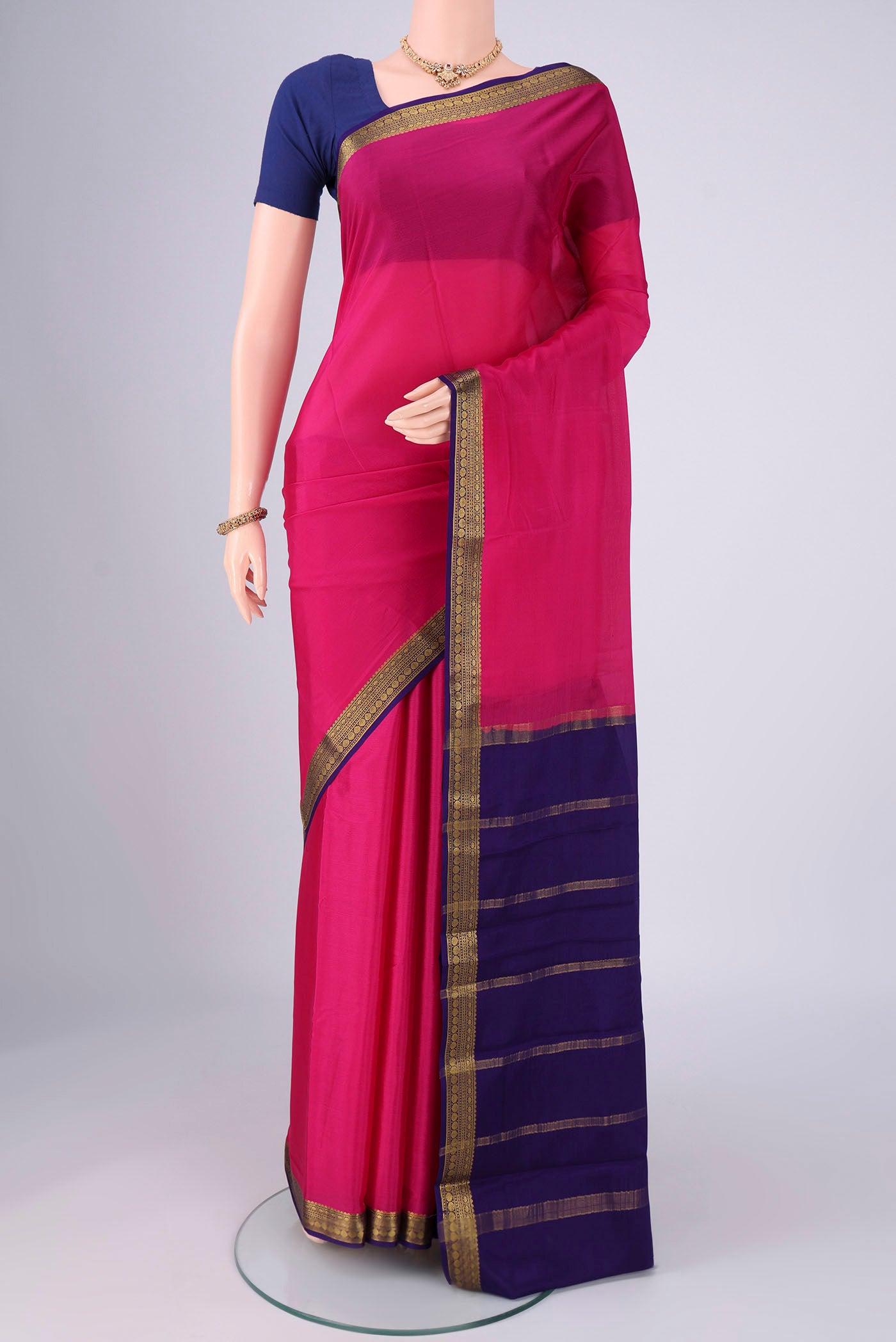 Rani Pink Mysore Crepe Saree with Plain Body and Zari Border.  displayed on a mannequin