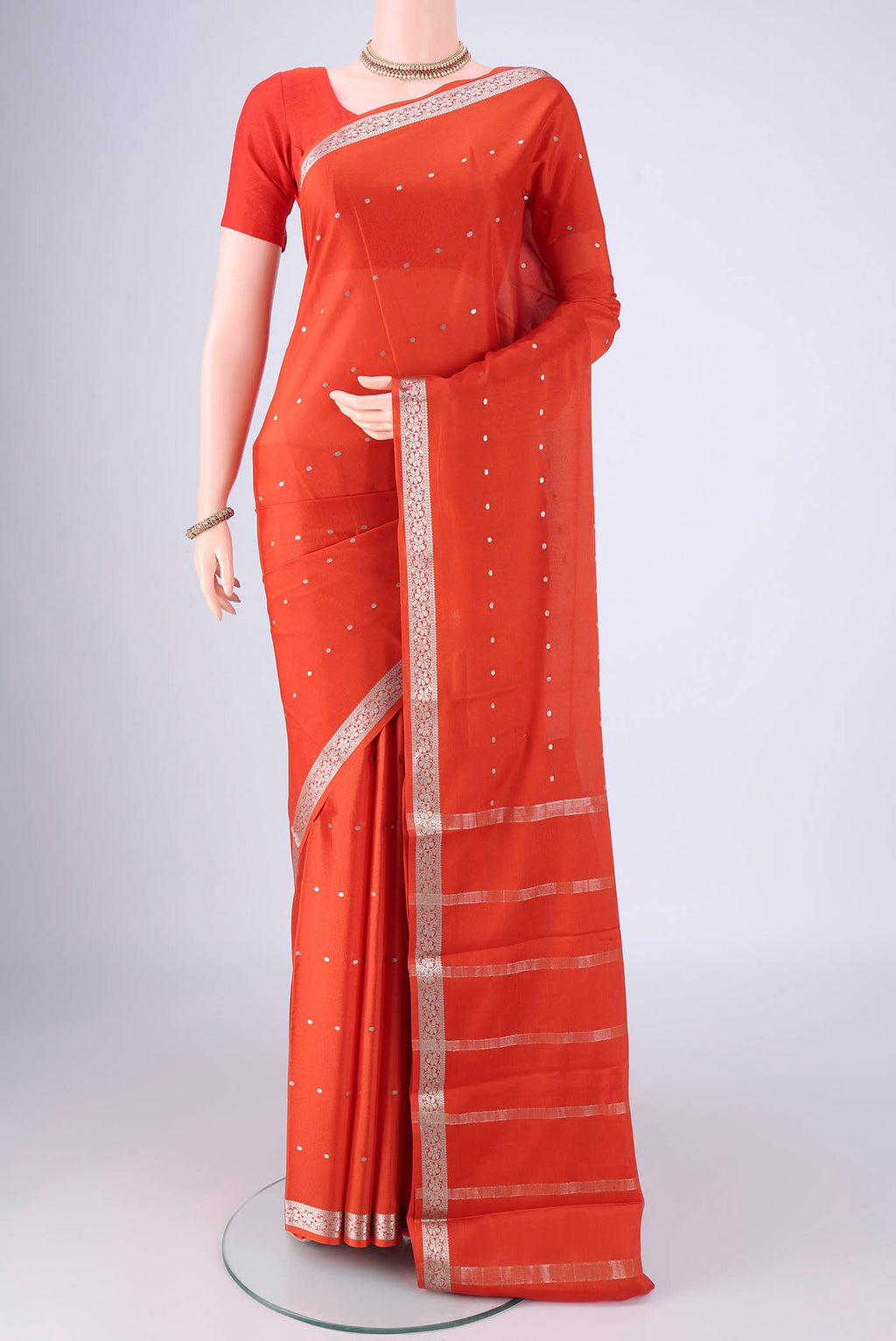 Rust Mysore Crepe Saree with Zari Butta on the body and Zari Border.  displayed on a mannequin