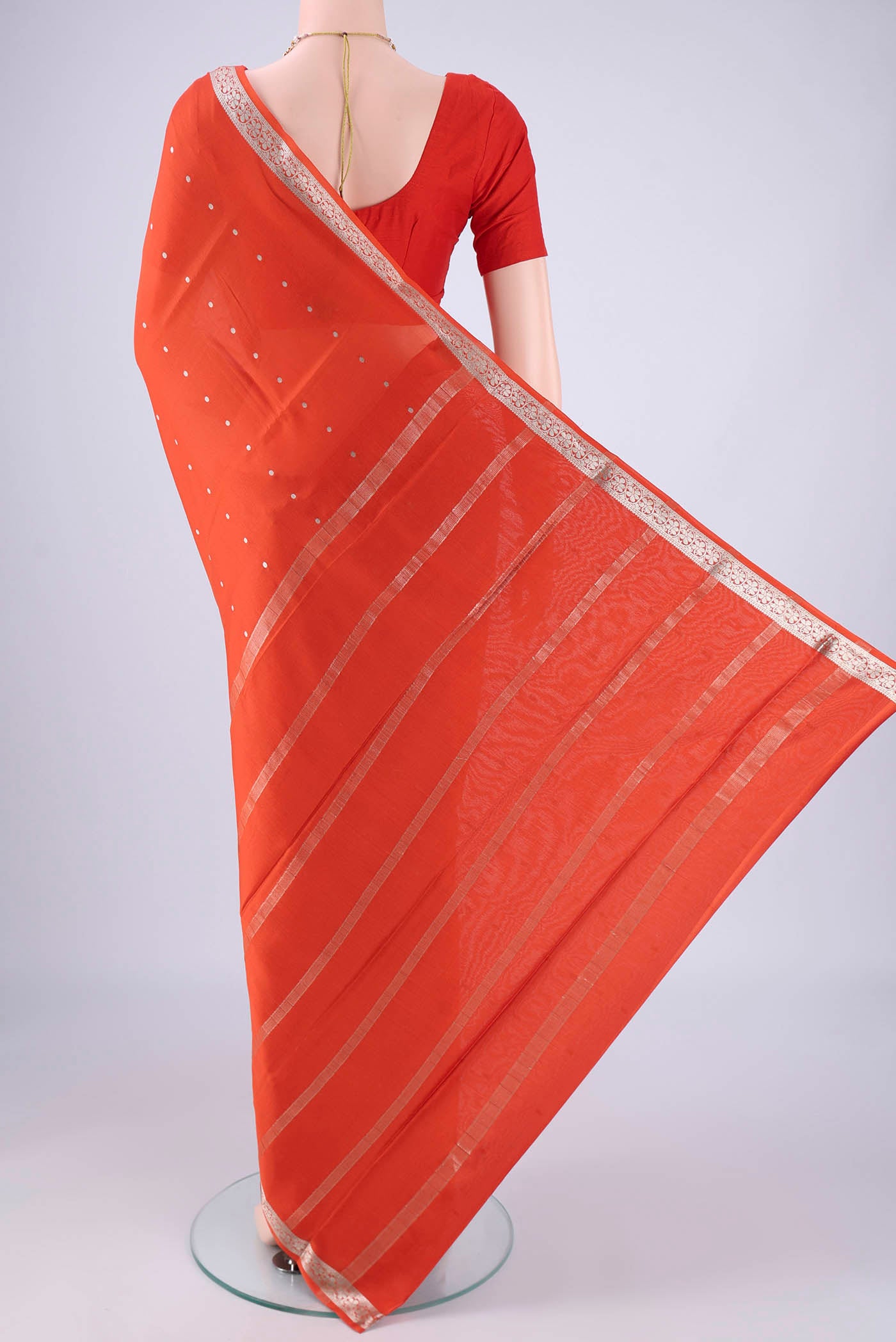 Flat view of Rust Mysore Crepe Saree with Zari Butta on the body and Zari Border. 