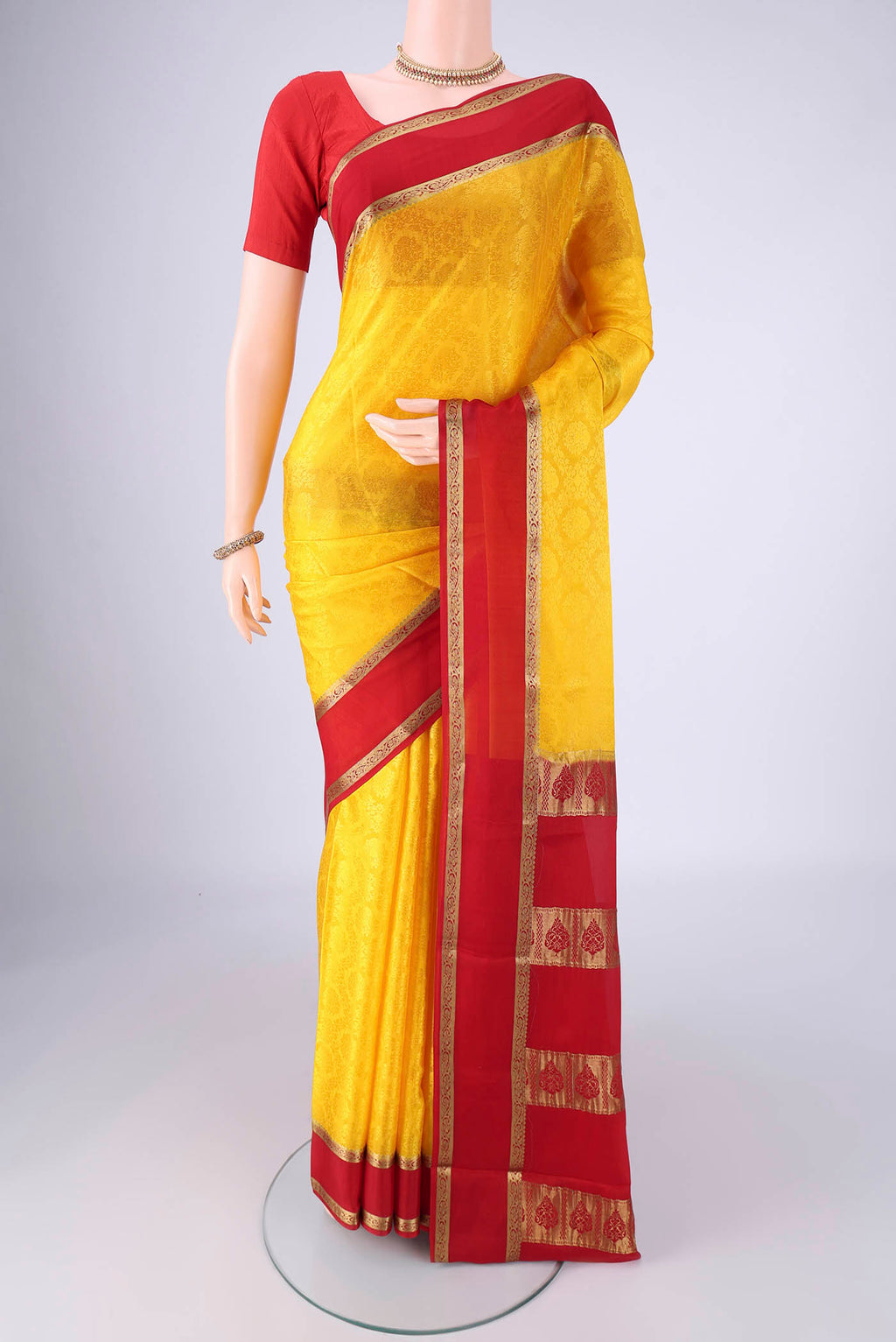 Yellow Mysore Crepe Saree with Jacquard design on the body and Zari Border.  displayed on a mannequin