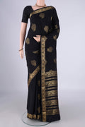 Black Mysore Crepe Saree with Zari Butta on the body and Zari Border.  displayed on a mannequin