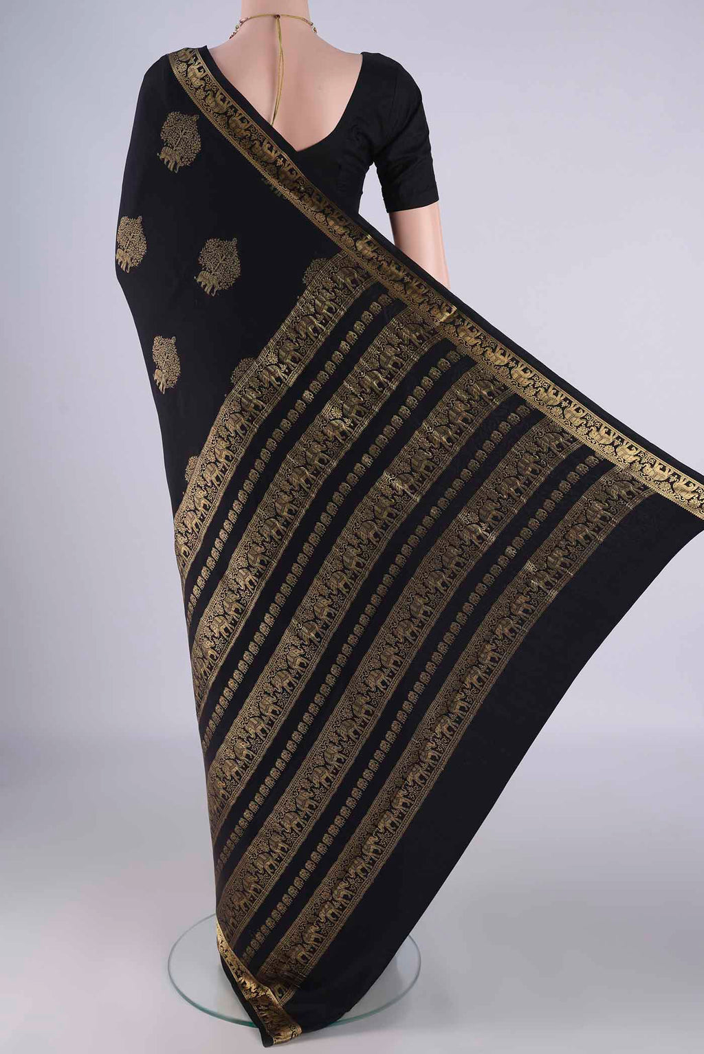 Flat view of Black Mysore Crepe Saree with Zari Butta on the body and Zari Border. 