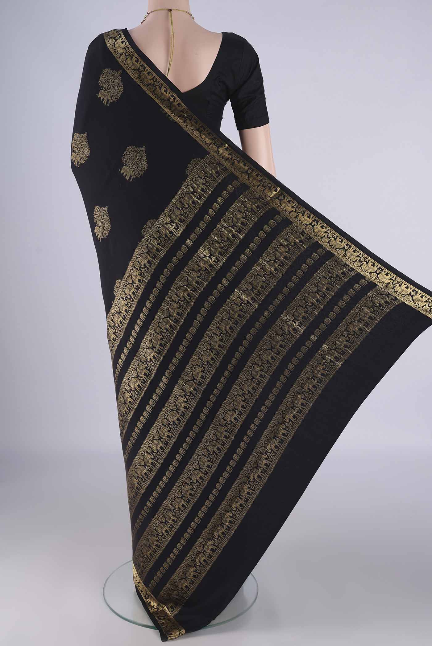 Flat view of Black Mysore Crepe Saree with Zari Butta on the body and Zari Border. 