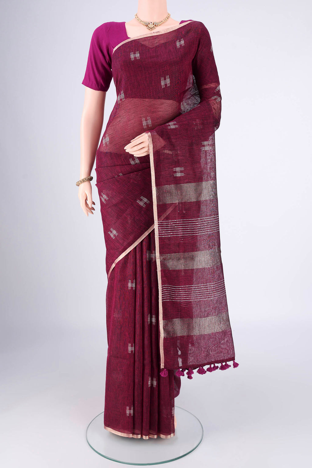 Light Magenta Linen Cotton Saree with Thread Butta on the body and Zari Border.  displayed on a mannequin