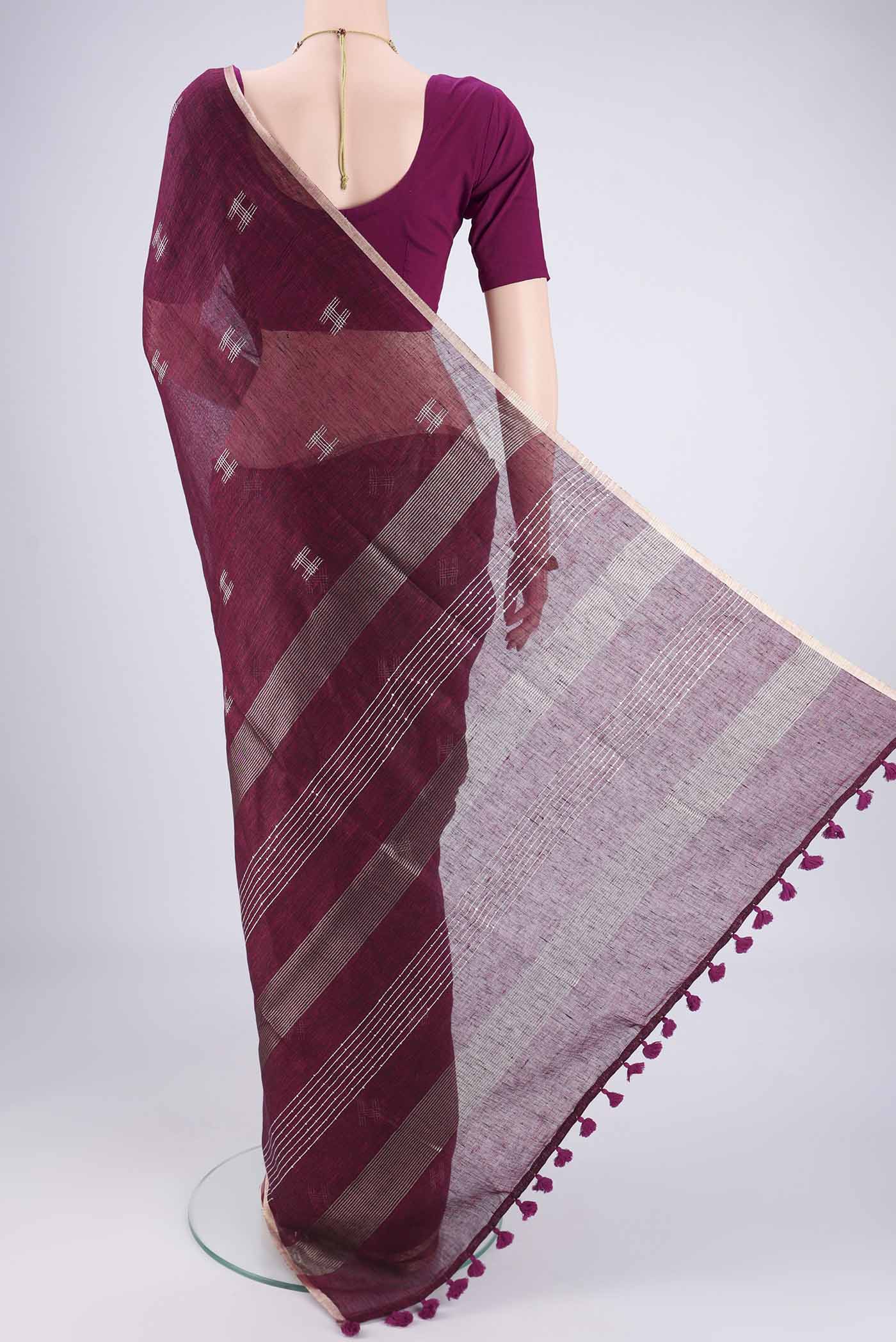 Flat view of Light Magenta Linen Cotton Saree with Thread Butta on the body and Zari Border. 