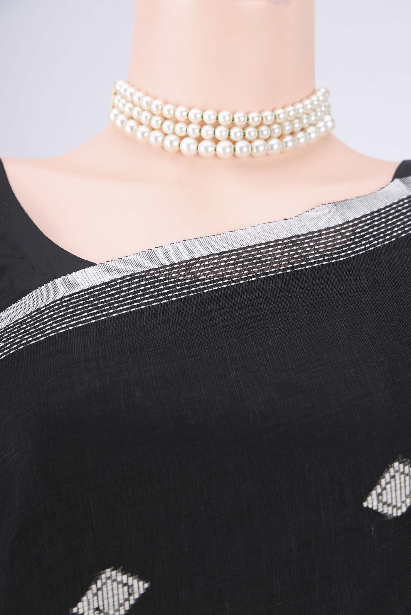 Border image of Black Linen Cotton Saree with Thread Butta on the body and Zari Border. 