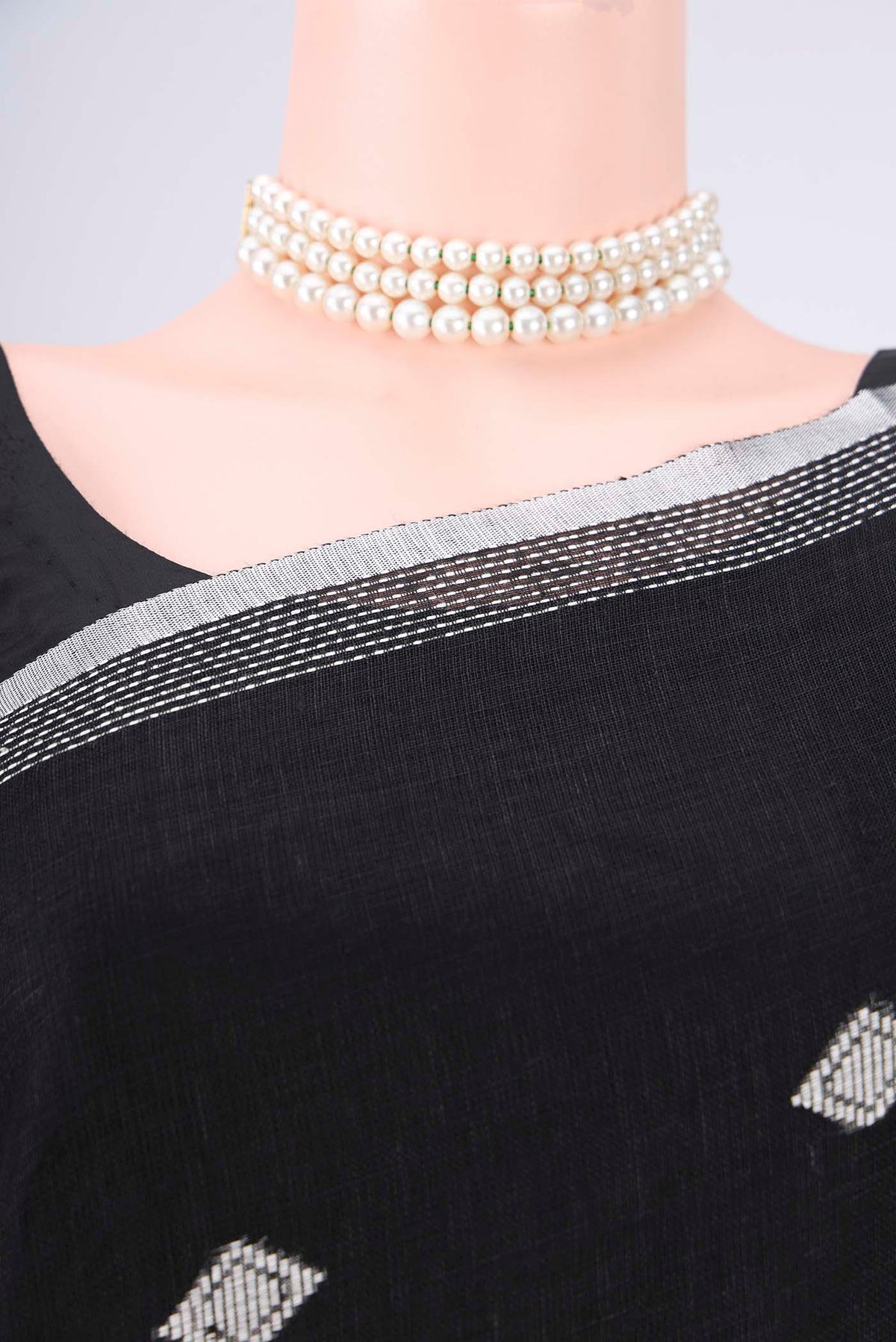 Border image of Black Linen Cotton Saree with Thread Butta on the body and Zari Border. 