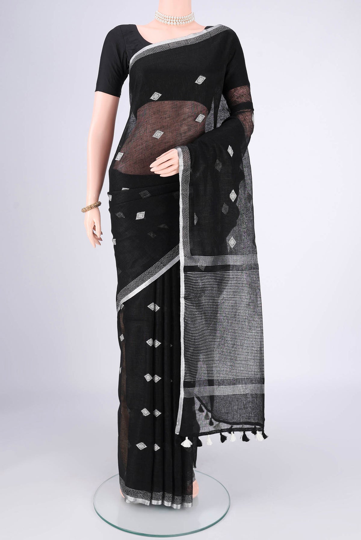 Black Linen Cotton Saree with Thread Butta on the body and Zari Border.  displayed on a mannequin