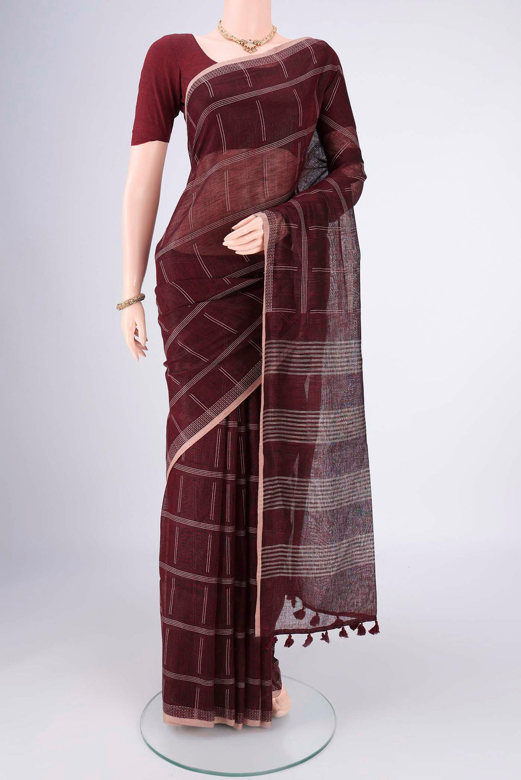 Maroon Linen Cotton Saree with Stripes on the body and Plain Border.  displayed on a mannequin