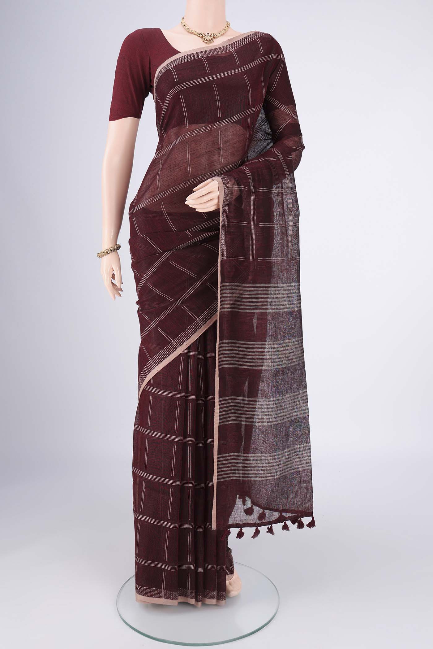 Maroon Linen Cotton Saree with Stripes on the body and Plain Border.  displayed on a mannequin