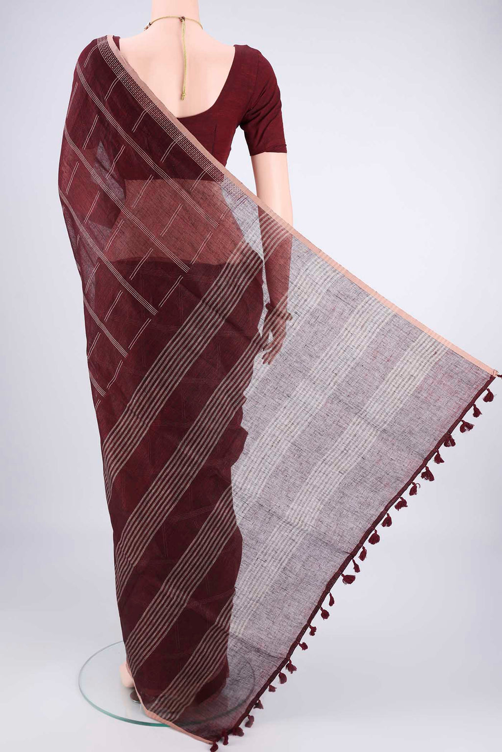 Flat view of Maroon Linen Cotton Saree with Stripes on the body and Plain Border. 