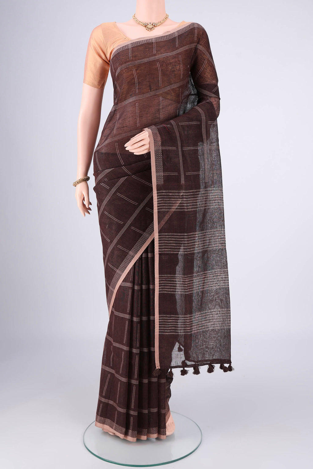 Brown Linen Cotton Saree with Stripes on the body and Plain Border.  displayed on a mannequin