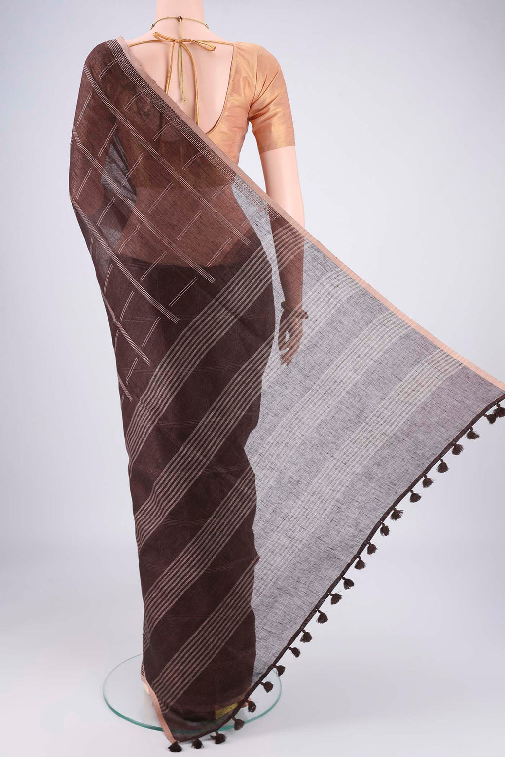 Flat view of Brown Linen Cotton Saree with Stripes on the body and Plain Border. 