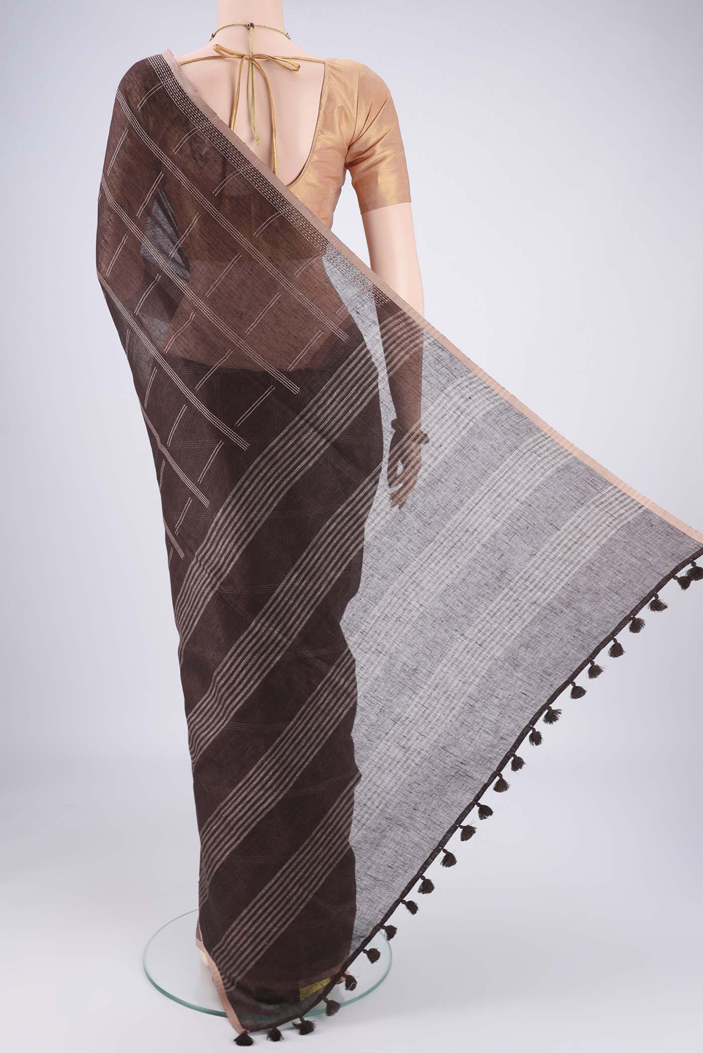 Flat view of Brown Linen Cotton Saree with Stripes on the body and Plain Border. 