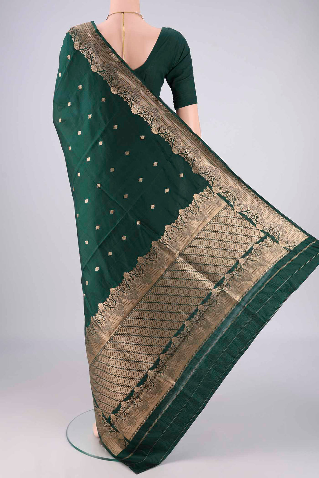 Flat view of Bottle Green Banarasi Katan Silk Saree with Zari Butta on the body and Zari Border. 