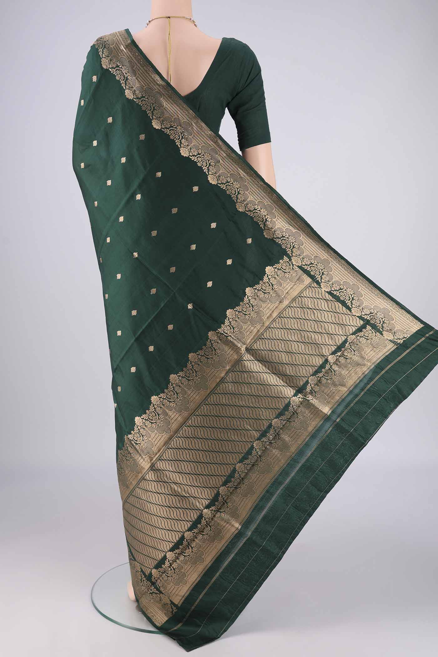 Flat view of Bottle Green Banarasi Katan Silk Saree with Zari Butta on the body and Zari Border. 